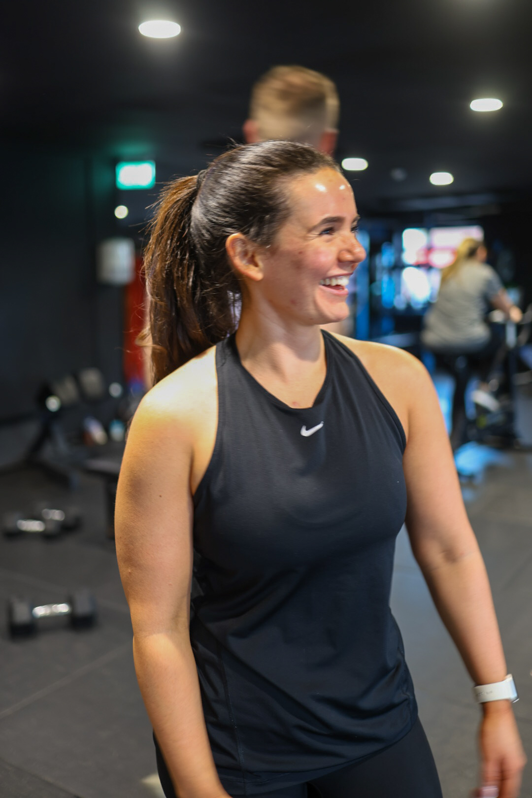 Woman smiling during a workout at Momentum Fitness